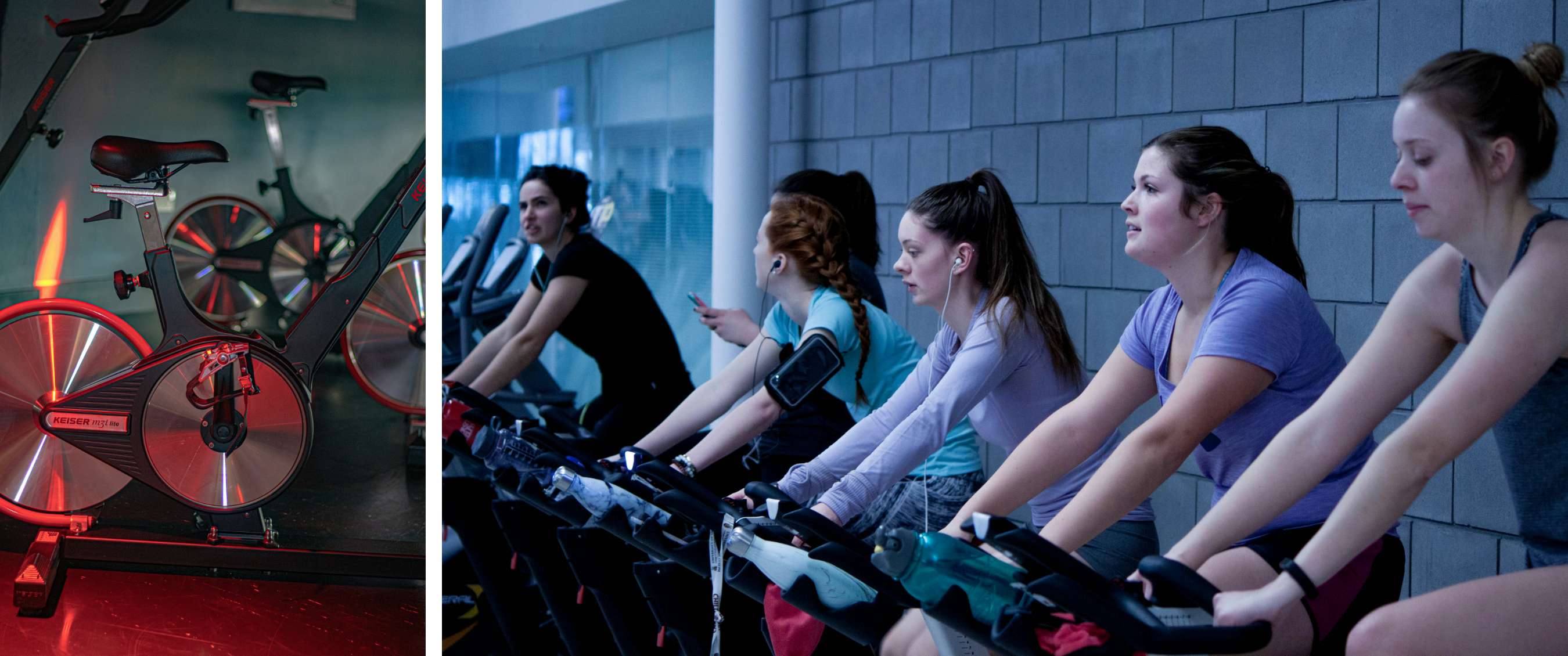 Meerdere personen fietsen naast elkaar op hometrainers in een indoor sportruimte.