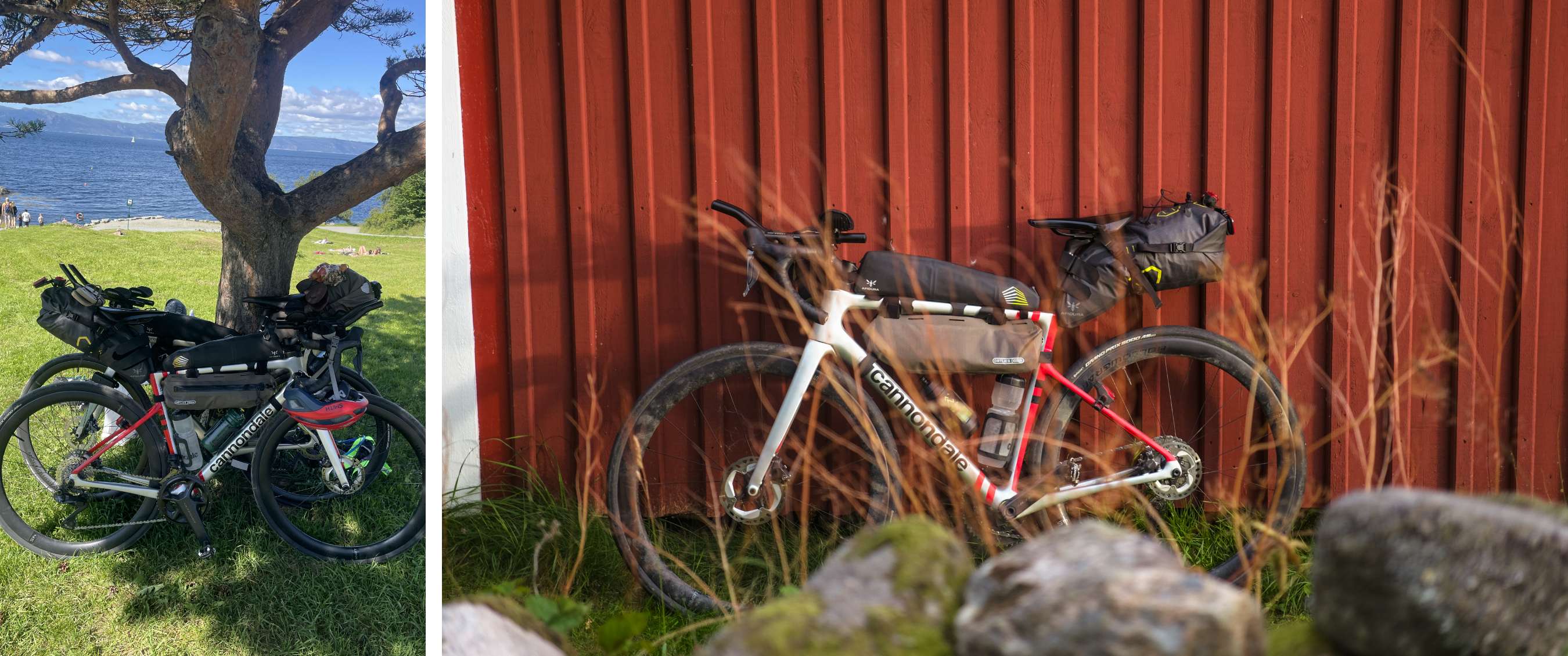 Een bepakte Cannondale-fiets staat tegen een rood gebouw, met gras en rotsen op de voorgrond.