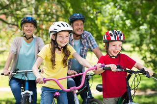 Happy family on their bike at the park on a sunny day