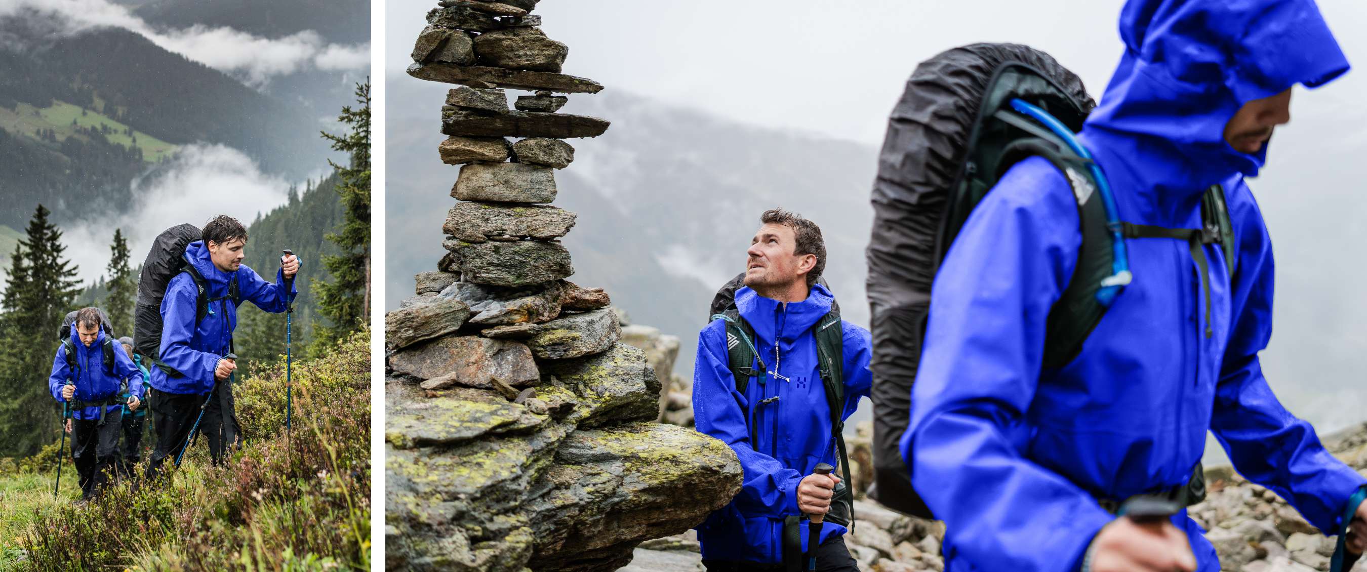 Twee wandelaars in blauwe regenjassen met rugzakken en wandelstokken op een rotsachtig bergpad.